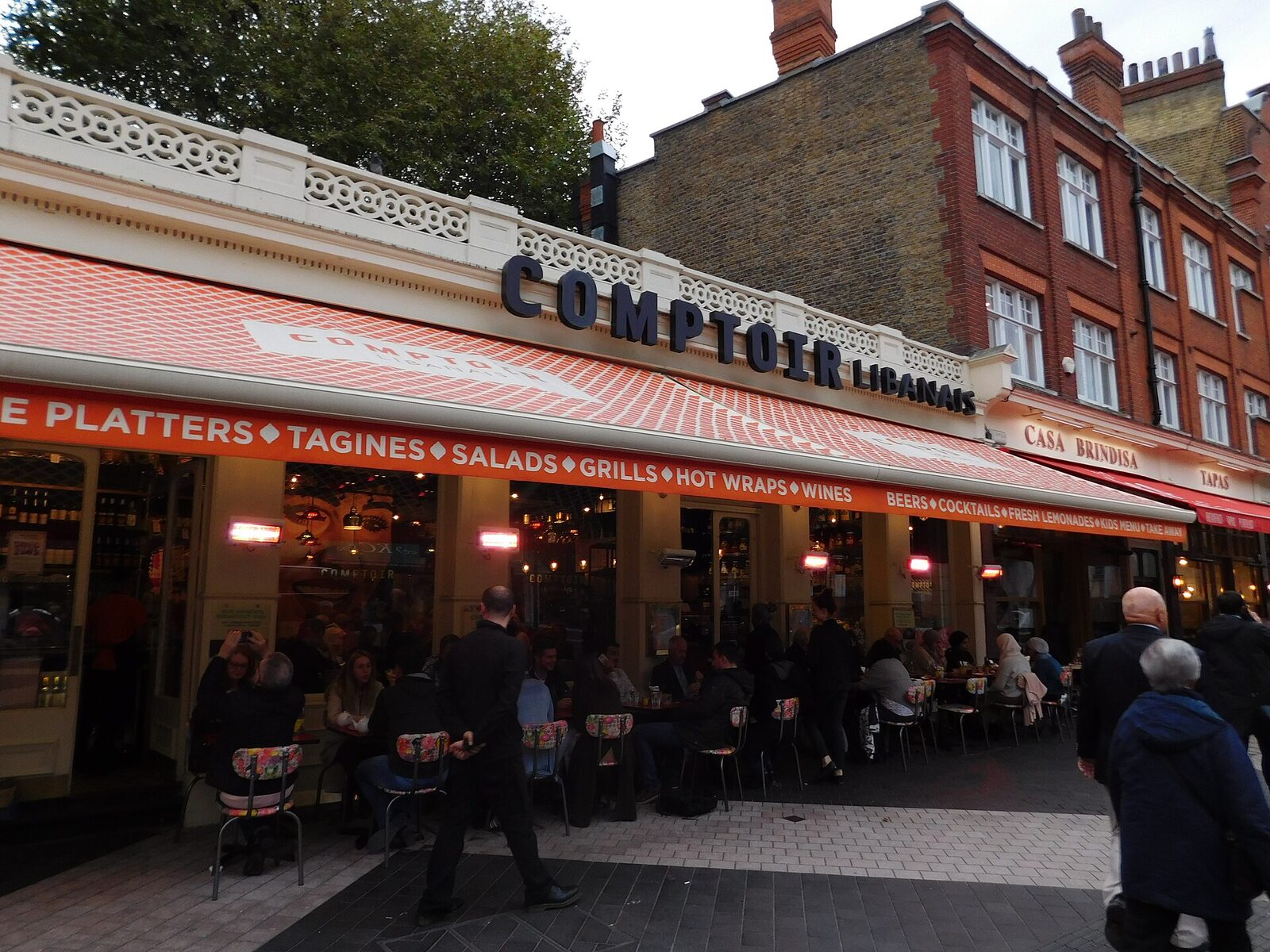 Diners at the outdoor tables of Comptoir Libanais on Exhibition Road, South Kensington
